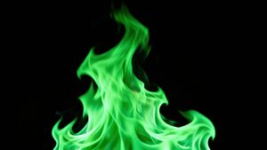 Bright green flames upon a black background